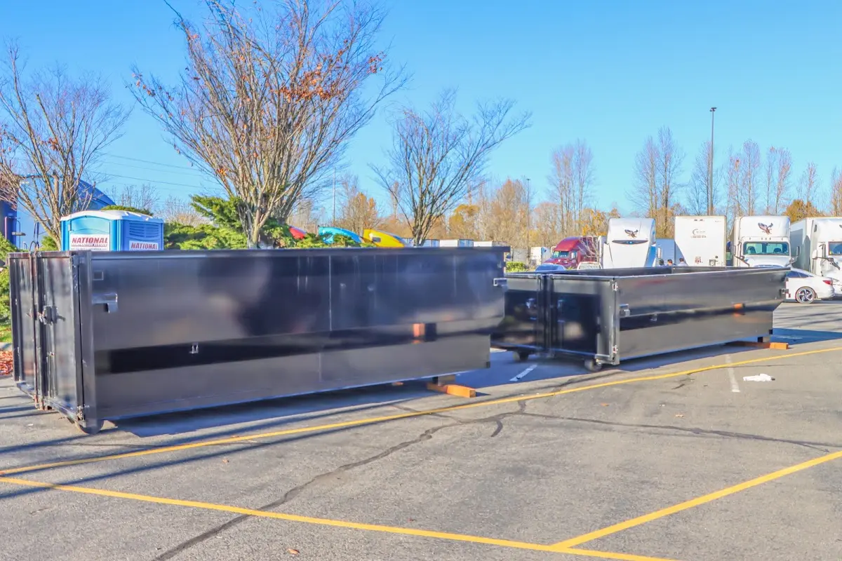 Professional dumpster rental service with roll-off container on residential driveway in Bangor